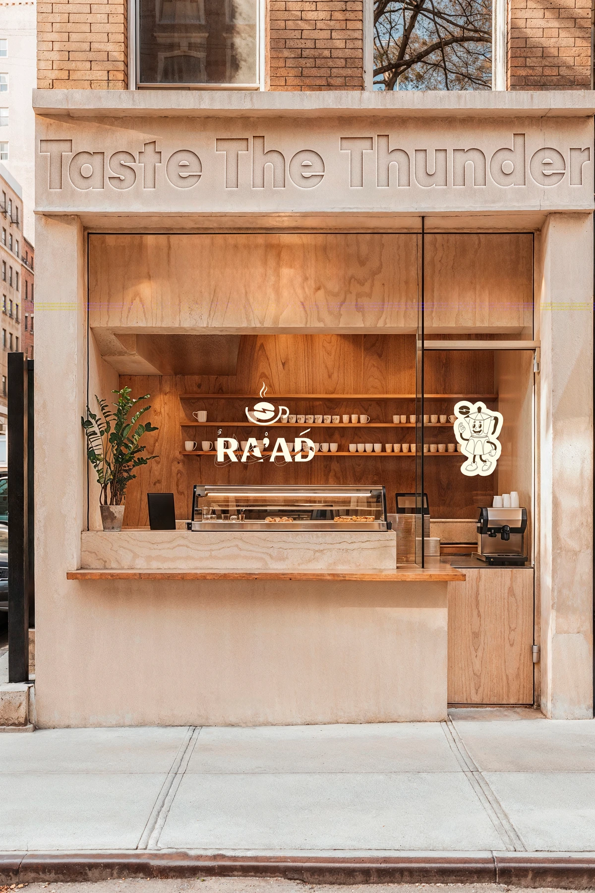 The RA’AD storefront: “Taste The Thunder” carved above a wood-lined window, with the RA’AD logo and mascot on the glass